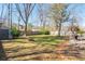 Spacious backyard with mature trees, a fire pit, and outdoor seating at 529 Laurel Ridge Rd, North Charleston, SC 29418
