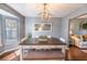Inviting dining room featuring a modern chandelier, neutral gray walls, and a sunlit window at 529 Laurel Ridge Rd, North Charleston, SC 29418