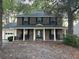Charming two-story brick home with black shutters, rocking chairs, and a covered front porch at 529 Laurel Ridge Rd, North Charleston, SC 29418