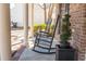 Charming front porch with rocking chairs and decorative potted plants next to the brick house at 529 Laurel Ridge Rd, North Charleston, SC 29418