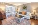 Cozy living room with a comfortable sofa, decorative rug, side tables, and an archway to the dining room at 529 Laurel Ridge Rd, North Charleston, SC 29418