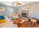 Bright living room featuring a stone fireplace, plush seating, and ample natural light from large windows at 529 Laurel Ridge Rd, North Charleston, SC 29418