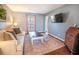 Comfortable living room with a plush sofa, stylish rug, flat-screen TV, and a decorative chest at 529 Laurel Ridge Rd, North Charleston, SC 29418