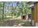 Backyard featuring a shed, lush trees, and an air conditioning unit at 5375 Highway 174, Adams Run, SC 29426