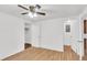 Bright bedroom with hardwood floors, a ceiling fan, and doors to a closet and other rooms at 5375 Highway 174, Adams Run, SC 29426