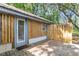 Home featuring a wooden deck with privacy fence, exterior door, and natural sunlight at 5375 Highway 174, Adams Run, SC 29426