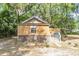 Exterior view of a home with wooden siding, complemented by natural surroundings and mature trees at 5375 Highway 174, Adams Run, SC 29426