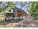 Exterior home view featuring wood siding, AC unit on elevated platform, and natural surroundings at 5375 Highway 174, Adams Run, SC 29426