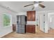 Kitchen featuring a stainless steel refrigerator, rich wood cabinetry, and a well-lit window at 5375 Highway 174, Adams Run, SC 29426