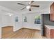 Open concept kitchen with stainless steel refrigerator, hardwood floors, and a ceiling fan at 5375 Highway 174, Adams Run, SC 29426