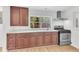 Kitchen showcasing rich wood cabinetry, stainless steel appliances, and a sink under a window at 5375 Highway 174, Adams Run, SC 29426