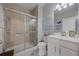 Clean bathroom featuring a glass-enclosed shower, toilet, vanity, neutral tiling and soft accents at 546 Sea Foam St, Summerville, SC 29486