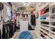Spacious walk-in closet with custom shelving, ample storage, and a tufted ottoman, maximizing organization at 546 Sea Foam St, Summerville, SC 29486