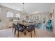 Open-concept dining area features a modern light fixture, glass table, seating for six, and neutral decor at 546 Sea Foam St, Summerville, SC 29486