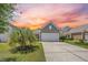 Charming home with a two-car garage, landscaped yard, and vibrant sunset view at 546 Sea Foam St, Summerville, SC 29486