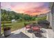 Charming patio area with a table set, grill, and peaceful pond views at 546 Sea Foam St, Summerville, SC 29486