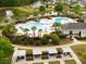 This aerial view showcases the community pool with ample seating and a bocce ball court nearby at 546 Sea Foam St, Summerville, SC 29486