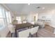 Open-concept living room with a dining area, a kitchen island with bar seating, and large windows for natural light at 553 Pender Woods Dr, Summerville, SC 29486