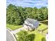 Aerial view of a lovely home with a well manicured lawn and bordered by mature trees at 610 Knowledge Dr, Ladson, SC 29456