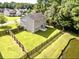 Aerial view of a backyard with a well maintained lawn, patio seating, and privacy fence at 610 Knowledge Dr, Ladson, SC 29456