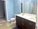 Bathroom features a double sink vanity, modern fixtures, a toilet, and tiled floors creating a functional space at 610 Knowledge Dr, Ladson, SC 29456
