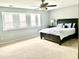 Comfortable bedroom features soft carpet, a ceiling fan, and a large bed creating a relaxing retreat at 610 Knowledge Dr, Ladson, SC 29456