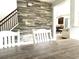 Dining room boasts stylish wood-look accent wall and a contemporary wooden table set for memorable meals at 610 Knowledge Dr, Ladson, SC 29456