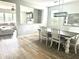 Bright dining room features a modern light fixture, neutral colors and seamless flow into the living area at 610 Knowledge Dr, Ladson, SC 29456