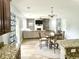 Living room displaying a cozy fireplace, large sectional couch, and a breakfast nook at 610 Knowledge Dr, Ladson, SC 29456