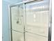 Contemporary bathroom shower featuring sliding glass doors, integrated shelves, and a modern showerhead fixture at 610 Knowledge Dr, Ladson, SC 29456
