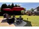 Spacious backyard with a patio area featuring a dining set, grill, and well-manicured lawn for relaxation and outdoor enjoyment at 7 Lavington Rd, Charleston, SC 29407