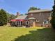 Large backyard with lush green grass, patio, and brick house creates a perfect setting for outdoor enjoyment at 7 Lavington Rd, Charleston, SC 29407