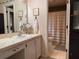 Well-lit bathroom features a vanity with a large mirror, with separate shower and toilet behind it at 7 Lavington Rd, Charleston, SC 29407