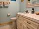 A well-lit bathroom with a white vanity, toilet, and coastal decor at 7 Lavington Rd, Charleston, SC 29407