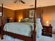 Inviting bedroom features a four-poster bed, hardwood floors, and warm lighting for a relaxing retreat at 7 Lavington Rd, Charleston, SC 29407