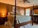 Spacious bedroom features a four-poster bed, hardwood floors, and warm lighting for a cozy atmosphere at 7 Lavington Rd, Charleston, SC 29407