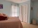 Comfortable bedroom boasts neutral carpet, a large closet, and light blue walls that create a calm and inviting atmosphere at 7 Lavington Rd, Charleston, SC 29407