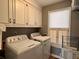 Functional laundry room featuring a washer and dryer, ample cabinet space, and natural light at 7 Lavington Rd, Charleston, SC 29407