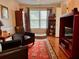 Cozy living room featuring hardwood floors, dark leather armchairs, and natural light from the window at 7 Lavington Rd, Charleston, SC 29407