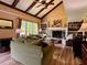 Spacious living room with vaulted ceilings, exposed beams, fireplace, and built-in bookshelves at 7 Lavington Rd, Charleston, SC 29407