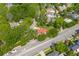 Aerial view showing a home with a red roof with a lush, tree-filled neighborhood at 7 Wesley Dr, Charleston, SC 29407