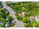 Aerial view showcases home surrounded by lush greenery and neighborhood streets at 7 Wesley Dr, Charleston, SC 29407