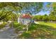 Charming home with a red roof, well-maintained lawn, complemented by mature trees at 7 Wesley Dr, Charleston, SC 29407