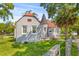Charming home with gray brick, orange roof, turret entrance, and well-maintained lawn, surrounded by mature trees at 7 Wesley Dr, Charleston, SC 29407