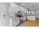 Modern kitchen featuring white cabinets, stainless steel appliances, granite countertops, and hardwood floors at 7 Wesley Dr, Charleston, SC 29407