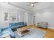 Spacious living room with hardwood floors, a ceiling fan, tray ceiling, and comfortable blue sofas at 7 Wesley Dr, Charleston, SC 29407