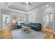 Inviting living room with tray ceiling, ceiling fan, hardwood floors, and natural light from multiple windows at 7 Wesley Dr, Charleston, SC 29407