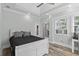 Comfortable main bedroom featuring a tray ceiling, ceiling fan, and wood-look floors at 7 Wesley Dr, Charleston, SC 29407