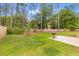 Spacious backyard features a patio, green grass, privacy fence and towering trees providing shade and privacy at 727 Hodge Rd, Summerville, SC 29483