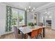 Elegant dining room featuring modern chandelier, large windows, and stylish chairs at 727 Hodge Rd, Summerville, SC 29483